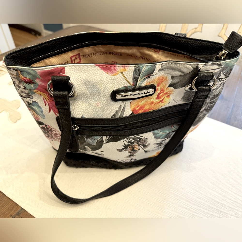 Stone Mountain USA floral print shoulder bag. Leather cutouts on front bottom.